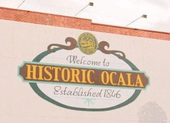 sign on side of building that reads, Welcome to Historic Ocala